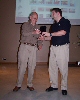 President Bruce Jones presenting coffee mug to Barnaby Jeans.