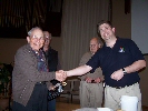 Barnaby presents Farney with his won copy of Windows 'Vista'.